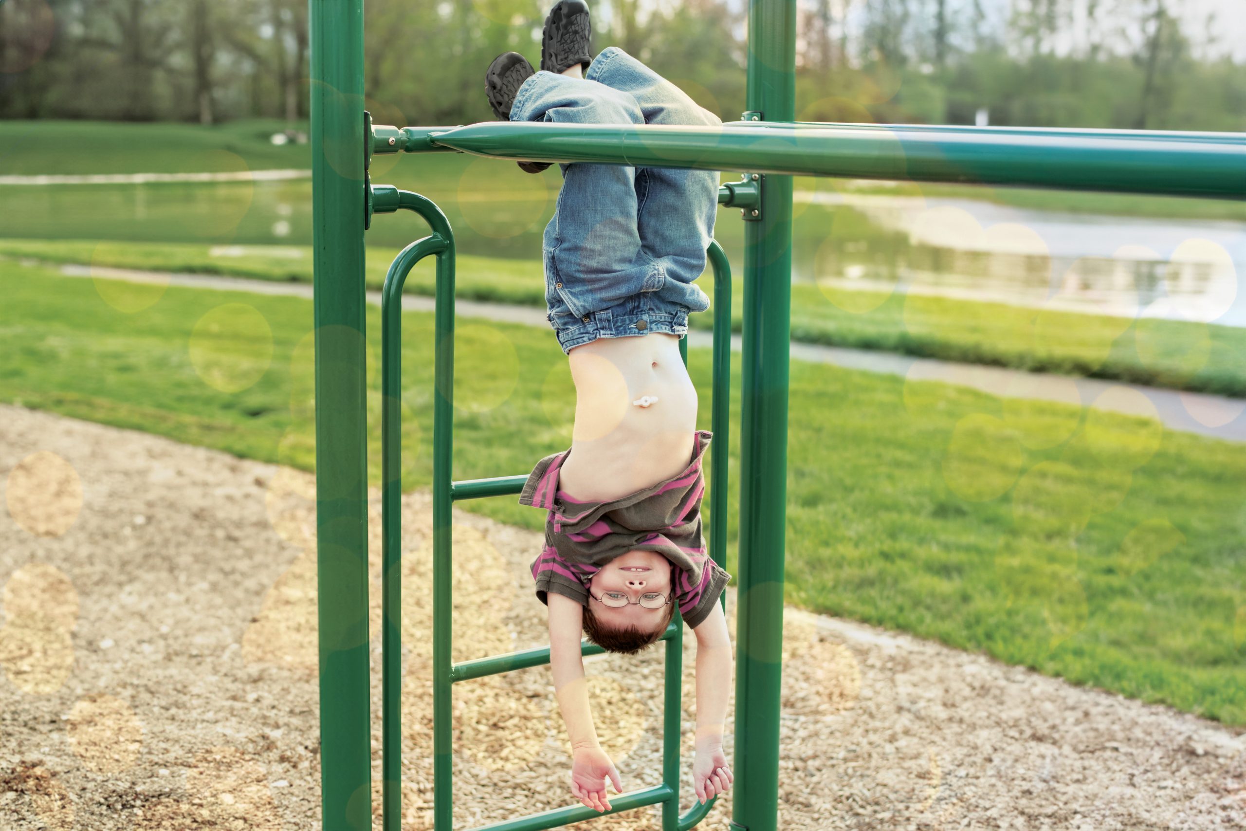Young boy on monkey bars with MIC button